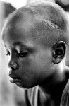 June 2000, Freetown, Sierra Leone. Ali Kondo, 10-years-old, was with the RUF for two years. His Commander, known as “Killer” was beating him because he couldn’t carry an AK 47 assault rifle. The scar on his head is the result of a machete used by his commander when he cried as the other children in his unit killed his father. © Franco Pagetti